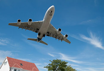 passenger-jet-over-house