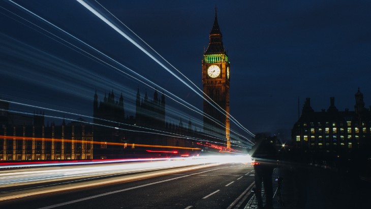 Big Ben at night. Time lapse photo so streaks of light are visible