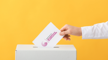 IMA branded card being posted into an election box