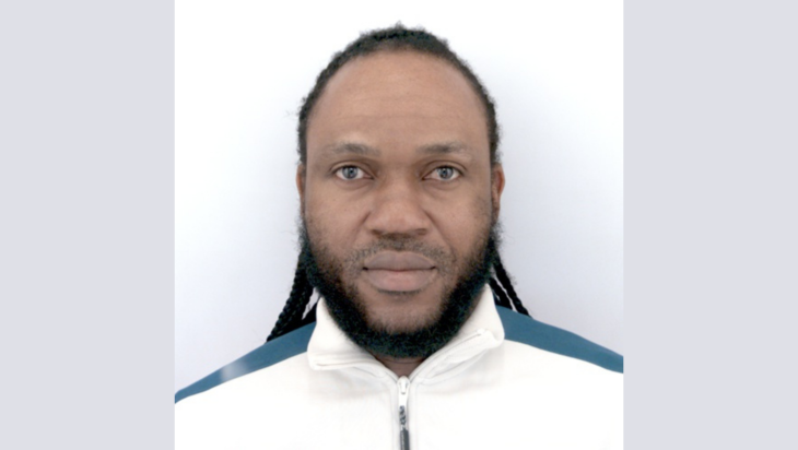 Charles Okon head and shoulders portrait, Charles is wearing a white jacket